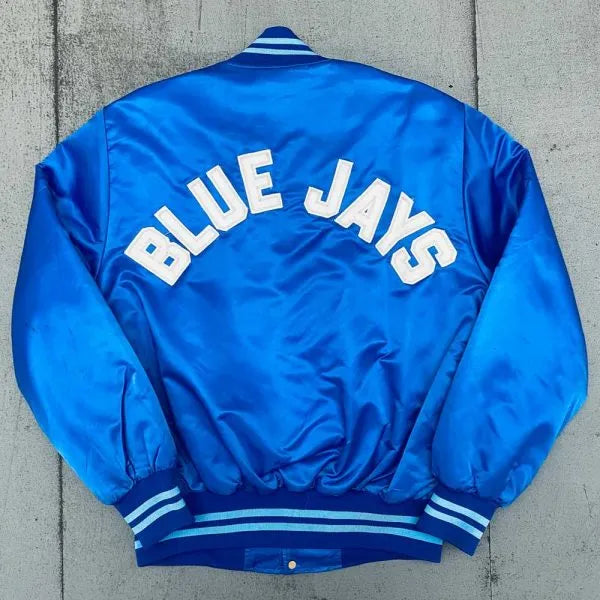 Blue jacket with 'BLUE JAYS' text on a concrete surface in American Style