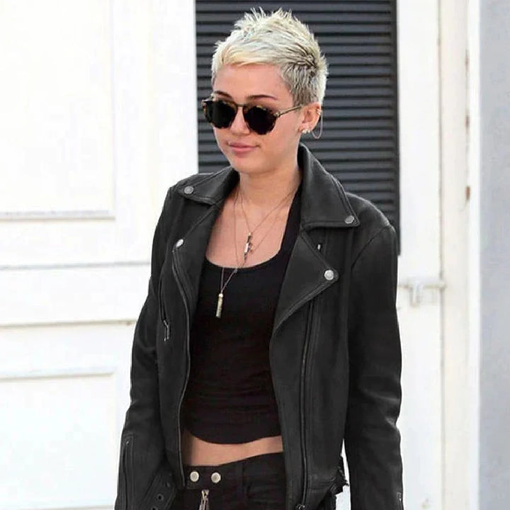 Person wearing a black leather jacket and sunglasses outdoors