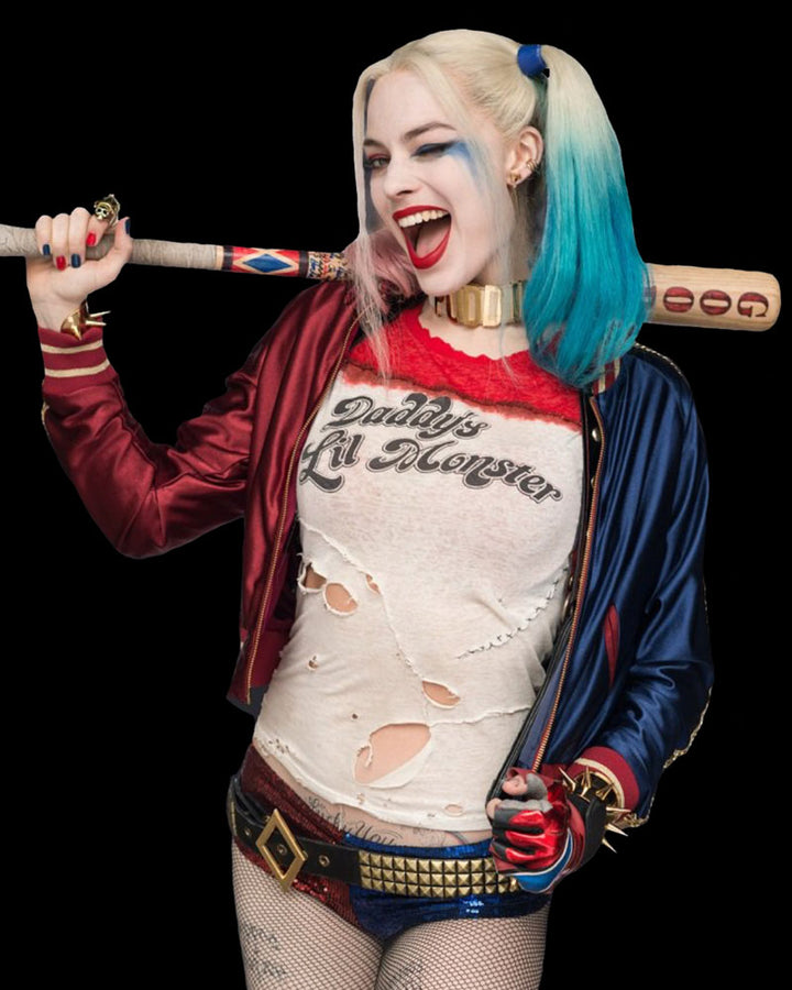 Person in Harley Quinn costume holding a baseball bat with a black background