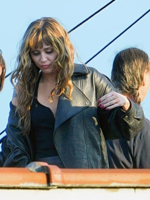 Woman wearing a black leather jacket with a blurred background