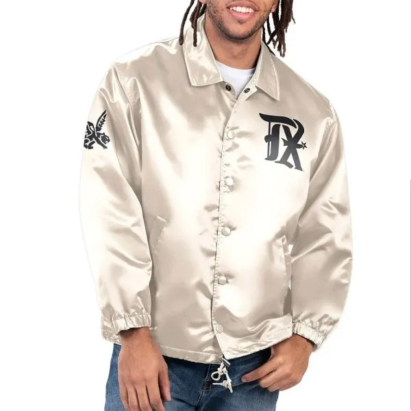 Person wearing a beige jacket with logos on sleeves and chest against a white background