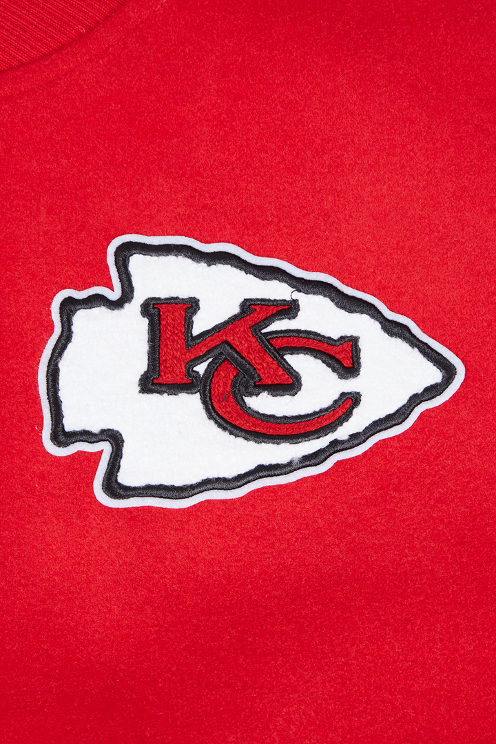 Detailed Kansas City Chiefs KC arrowhead logo embroidered on red fabric.